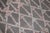 A mid 20th century Moroccan Kilim with a large scale geometric design on a charcoal ground