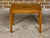 An English Campaign yew wood side table from circa 1920 with brass accents and straight legs. This English Campaign yew...