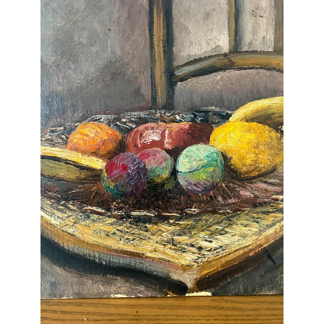 Acquired in France, a beautiful c. 1930s Parisian oil on panel of fruit. This pretty still life features fruit on a chair....