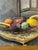 Acquired in France, a beautiful c. 1930s Parisian oil on panel of fruit. This pretty still life features fruit on a chair....