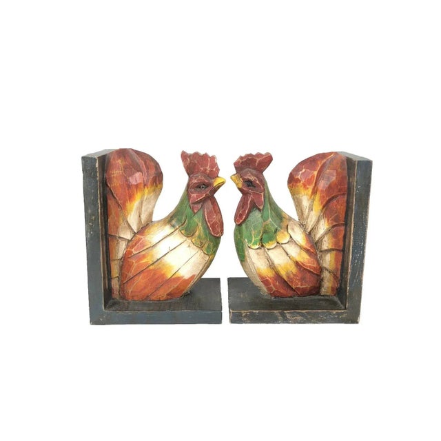 This pair of hand-carved wood bookends features a rustic rooster design, perfect for adding a touch of country charm to...