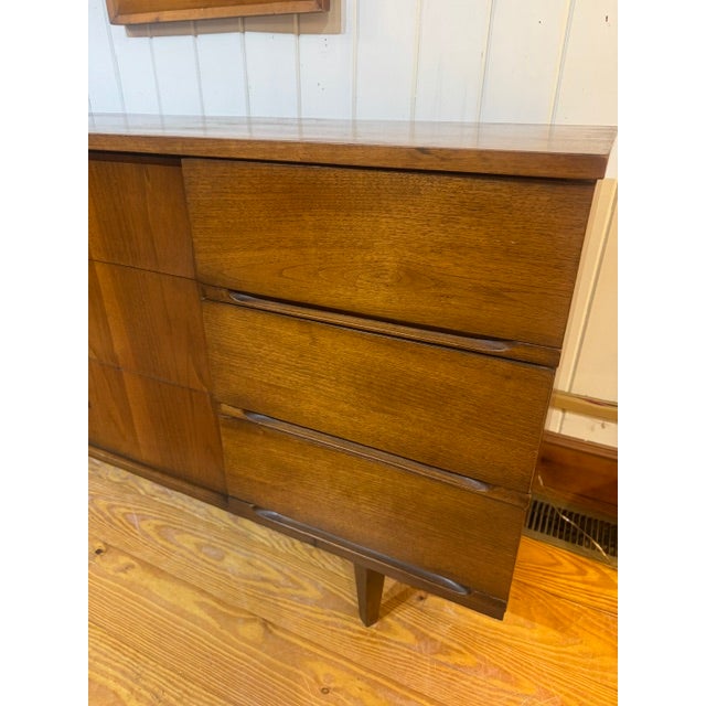 Vintage Mid-Century Modern Walnut Triple Low Boy Dresser, 9 drawers with Bow Tie chrome hardware and tapered legs. The...