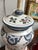 This elegant vintage Chinoiserie table lamp features a striking ginger jar-style ceramic base adorned with intricate blue,...