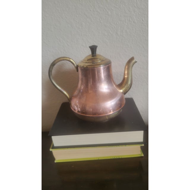 Vintage, small copper and brass vintage tea pot, the spout, handle, lid and bottom are made of brass while the rest is...