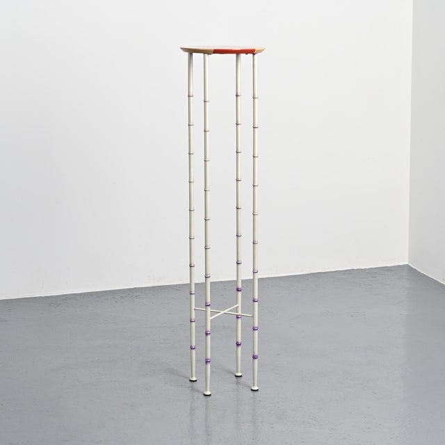 Polinio high side table, designed by Andrea Branzi circa 1990. Its slender structure is composed of thin metal uprights...