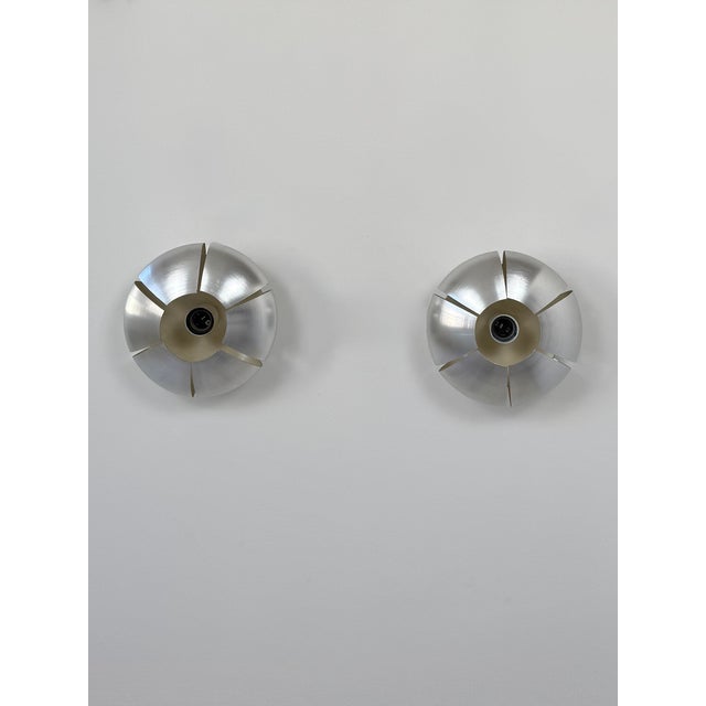 Pair of brushed aluminum wall lights produced in France in the 1970s. Original design with beautiful aluminum cutting and...