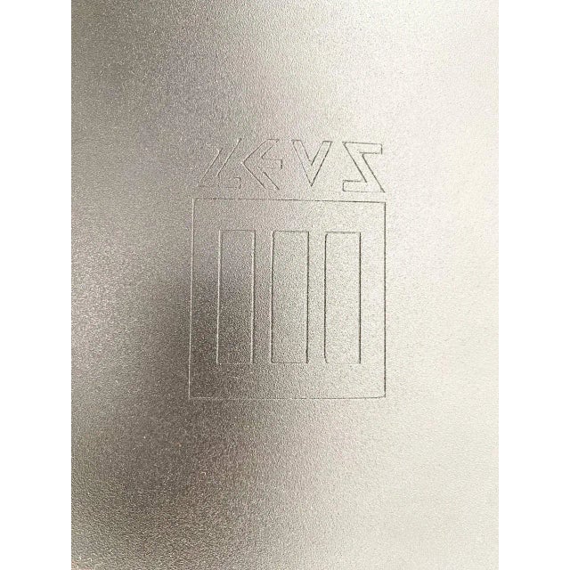 The chairs have a matt black metal structure with four square-section legs, the back of which extends all the way to the...