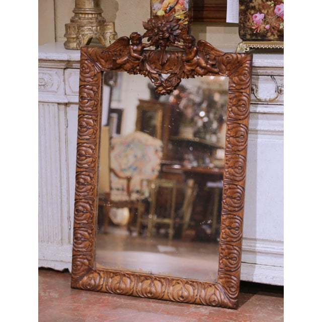 This elegant antique French wall mirror was crafted in solid oak circa 1860 and reflects the refined ornamental language...