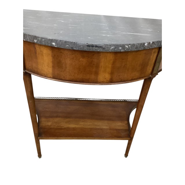 Pair of Louis XVI Style Marble Top Mahogany Brass Mounted Demi-Lune Consoles. Each with a thick marble top and a lower...