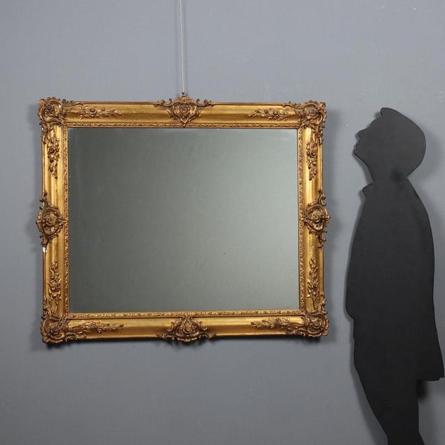 Carved and gilded wood and pastiglia mirror, moldings with leaf carvings and scrolls. Small defect. Italy, 20th century....