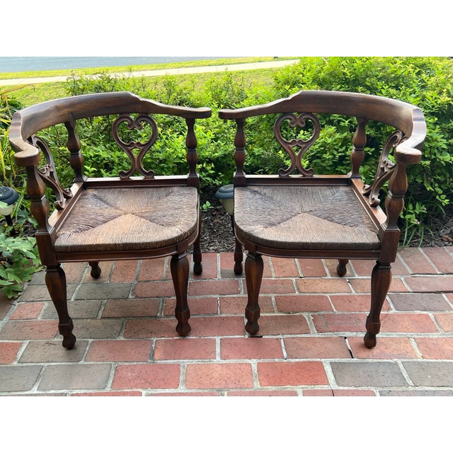 ThatKateGirl is please to offer this charming pair of Colonial Style carved oak corner chairs with rush seats. These...