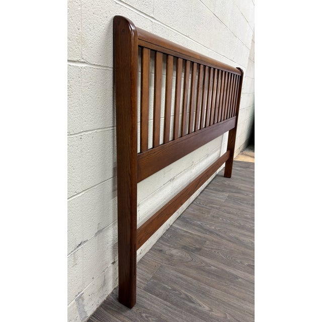 This is a gorgeous vintage king size Mission style oak headboard featuring a classic slatted design, warm medium-brown...