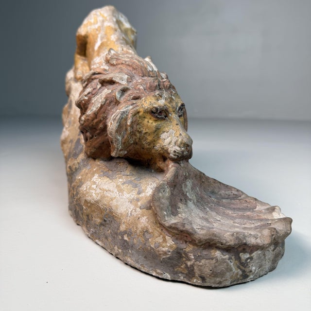A distinctive antique stone sculpture from calabria, southern italy, dating from 1880–1900. it depicts a reclining lion on...