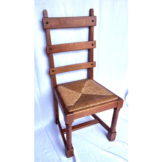 Imported from France. Set of six ladder-back chairs.. They are characterized by solid oak construction and traditional...