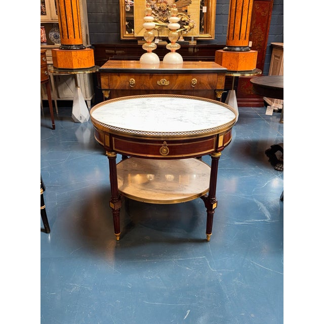 The French Louis XVI Mahogany Center Table is a luxurious and elegant piece of furniture that adds a touch of...