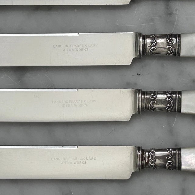 Set of Six Mother-of-Pearl Butter Knives by Landers, Frary & Clark (Aetna Works) Sterling Silver Markings Each butter...