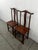 A matched pair of vintage Chinese-style yoke-back side chairs, crafted in hardwood and dating to the mid-20th century. The...