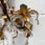 A beautiful gilt tole wall candle sconce. This piece is tall and features two arms, and accommodates 2 tapered candles. It...