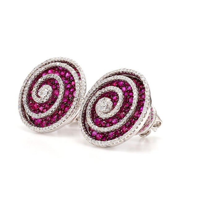 The Swirly Stud Earrings are a stunning addition to any jewelry collection. These earrings feature a unique swirling...