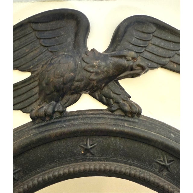Here is a wonderful statement mirror made from cast iron featuring a detailed eagle figure above a round mirror. The...