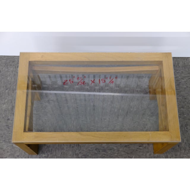 A low wood-framed table base, originally designed as an ottoman by Thierry Jeannot, restored by Carlton House with an...