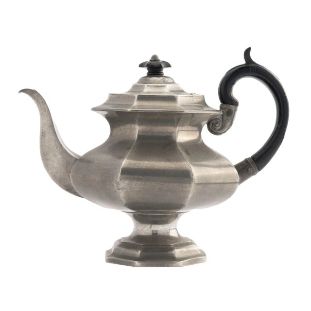 Three piece octagonal paneled pyriform pewter coffee service with creamer and covered sucrier. The coffee pot has an...