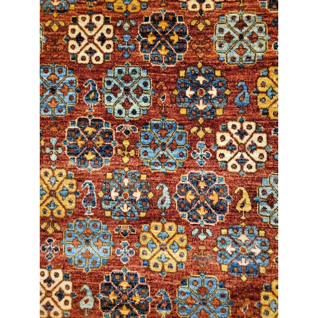This exquisite rug blends modern and traditional styles, showcasing a beautiful floral motif with rush field and accents...
