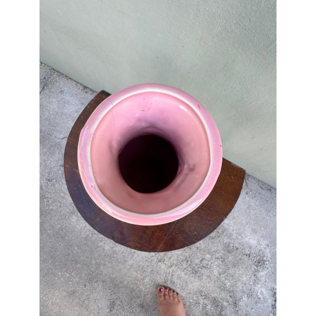 A delicate pink ceramic vase with three-dimensional hand-applied bird and cherry blossom branch relief — each petal...