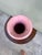 A delicate pink ceramic vase with three-dimensional hand-applied bird and cherry blossom branch relief — each petal...