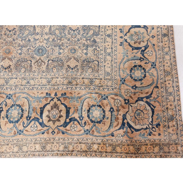 A finely-knotted late 19th century Persian Tabriz rug with an intricate abstract paisley design on a greenish beige field...