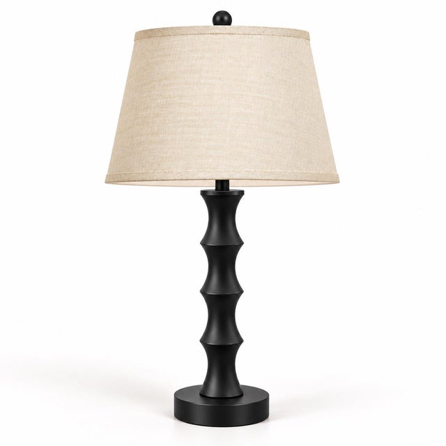 A striking pair of sculptural table lamps newly finished in a rich matte black, each featuring a rhythmic column of...