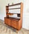 A versatile mid-century bookcase and storage unit with an integrated pull-out writing desk, dating from the 1960s. Crafted...