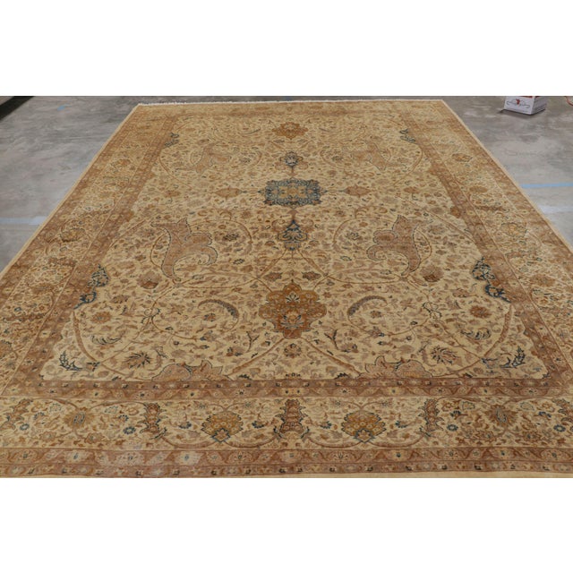 Made with hand-knotted wool circa 1920-1930, this 10x14 antique Persian rug of Tabriz provenance is a rare and exciting...