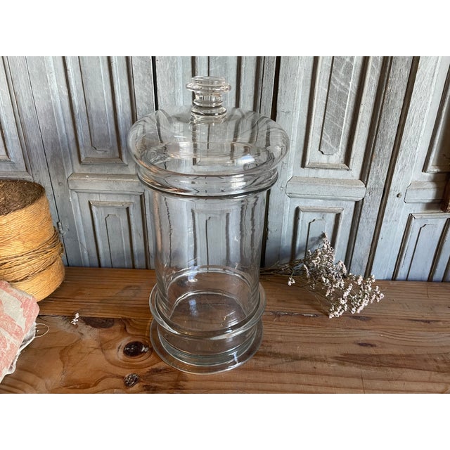 A large 19th-century candy jar from France. The jar is hand-blown and has an extra ring at the bottom. You will also...