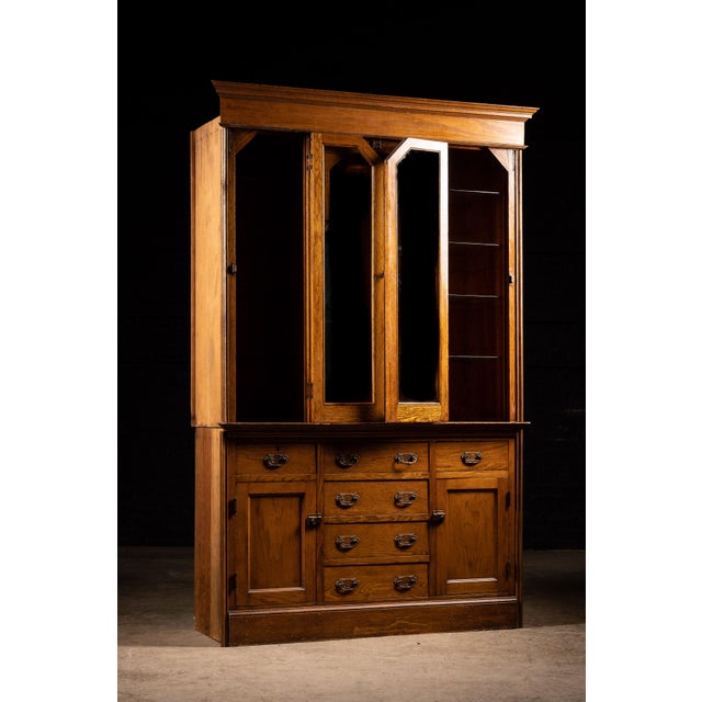 Early 20th century lighted hutch cabinet constructed of wood. 60"W x 21"D x 91.5"H. Originating in the home it was removed...