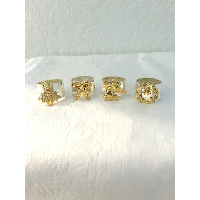 Charming set of eight Kemp & Beatley brass napkin rings. Silver-shaded brass octagon shaped ring with a gold-shaded brass...