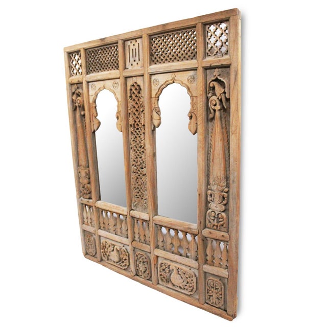An exceptional antique Indian architectural facade repurposed into a dramatic double mirror, this richly carved teak wood...