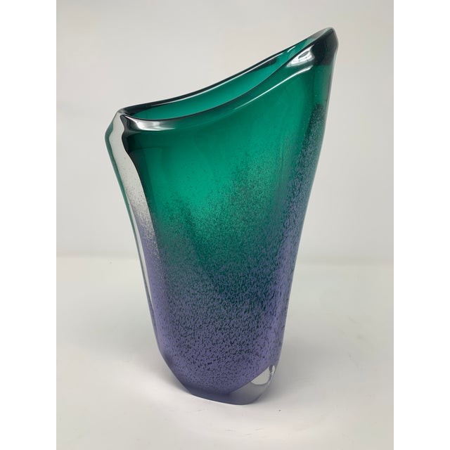 Hand-Blown Asymmetrical Art Glass Vase in Emerald and Smoky Blue A sculptural hand-blown art glass vase featuring a fluid,...
