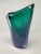 Hand-Blown Asymmetrical Art Glass Vase in Emerald and Smoky Blue A sculptural hand-blown art glass vase featuring a fluid,...