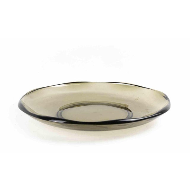 Glass decorative plate is an original decorative object realized in the 1970s. Original Art Glass. Fumé glass. Made in...