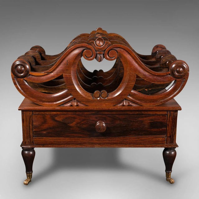 This is an antique Canterbury stand. An English, rosewood three sectioned magazine or newspaper rack, dating to the...