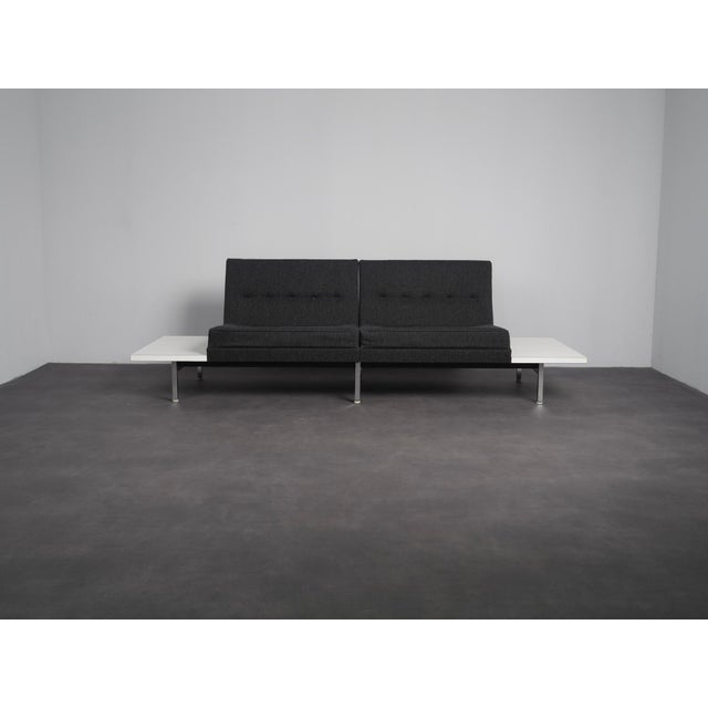 A 1960s two-seater sofa by george nelson for herman miller, part of his modular seating group. The design combines two...