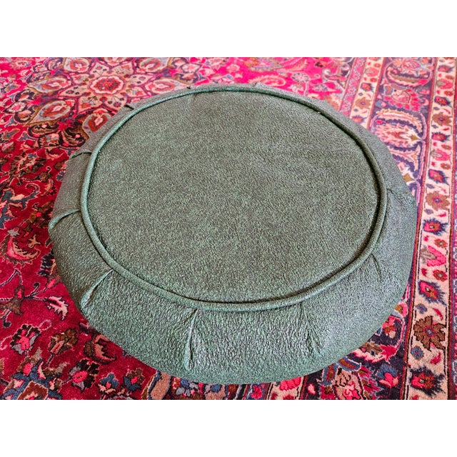 An MCM Atomic Mushroom Lava Textured Vinyl Ottoman with removable steel stamped diamond patterned tripod stand.