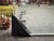 Single-piece structure in extra-clear, heat-curved glass, waterfall shape with a horizontal top and two folded sides....
