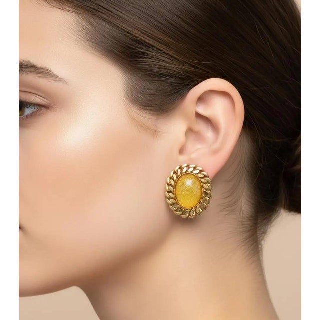 This pair of vintage 1970s Italian clip-on earrings combines classic elegance with bold glamour. Designed in a striking...