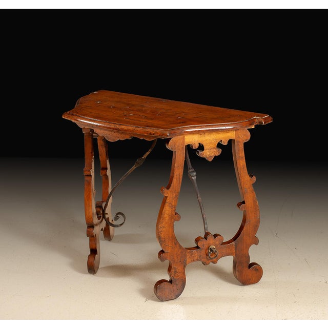 Handcrafted in Italy from select solid walnut, this console table reflects the rustic elegance and sculptural character of...