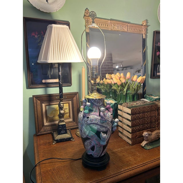 This chinoiserie lamp by Heyward House brings a smile with the climbing children and colorful ribbons. Set on a background...