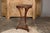 An Italian walnut guéridon side table from the early 19th century with parquetry top, carved apron, petite gilt spheres...