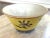 A beautiful, vivid yellow, vintage Chinese porcelain bowl. Hand painted cherry blossoms and flowers adorn this eye-...