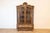 A Dutch walnut Rococo Revival bombé vitrine from the late 19th century, with glass doors and single drawer. Created in the...